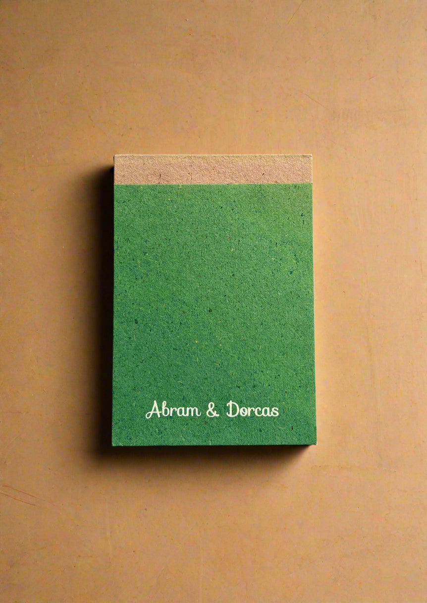 Green notebook with 'Abram & Dorcas' biodegradable notepad eco friendly notepad cotton paper