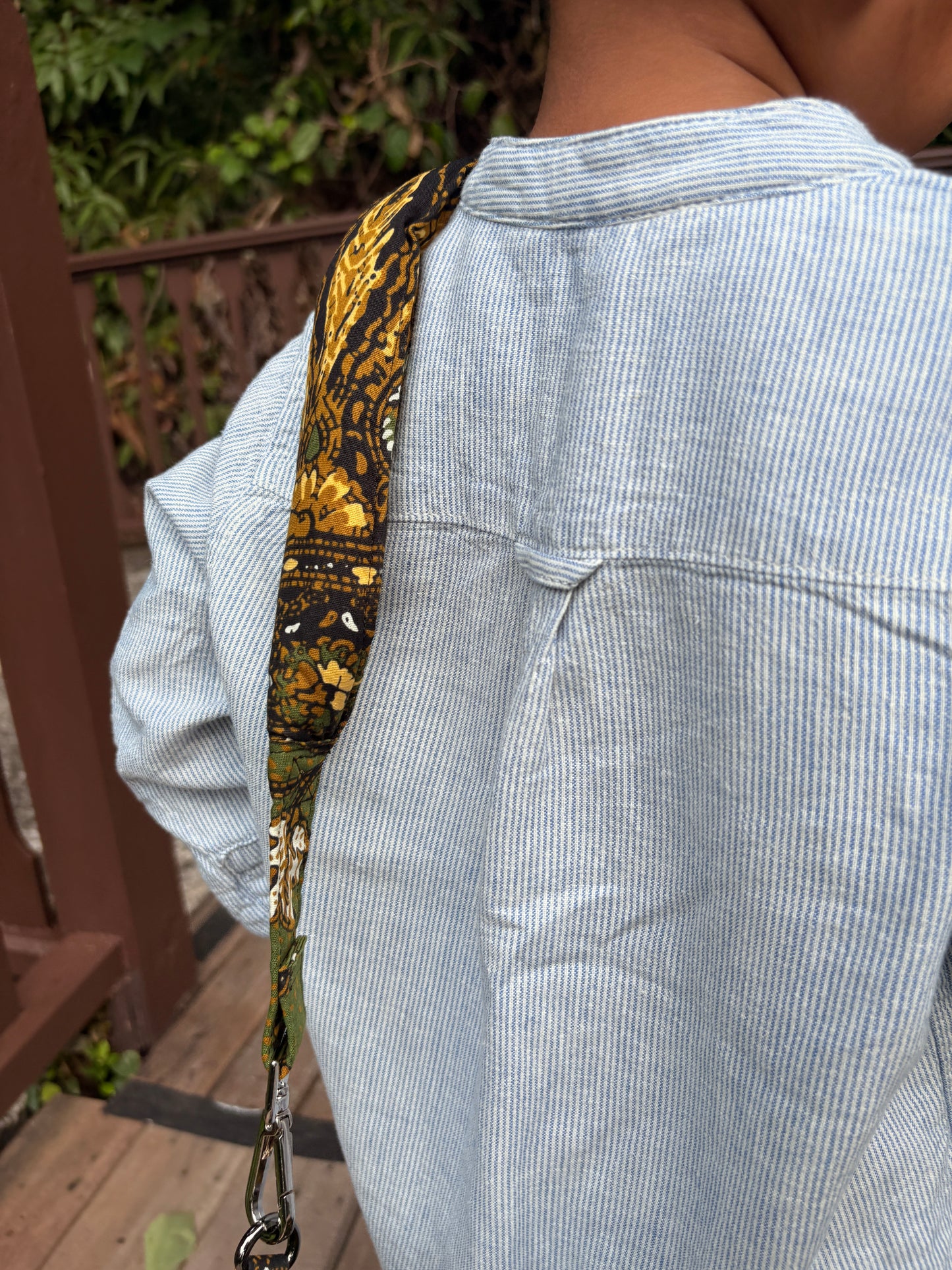 Handcrafted quilted black batik bag with leather zipper puller and YKK zipper, features a detachable padded shoulder strap.