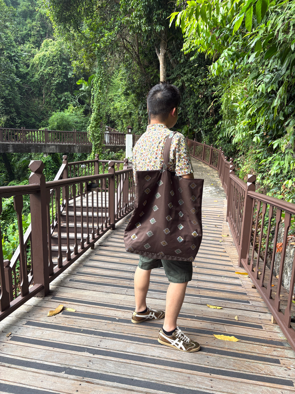 A dark brown Songket fabric bag, handcrafted in Singapore.