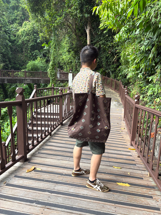 A dark brown Songket fabric bag, handcrafted in Singapore.