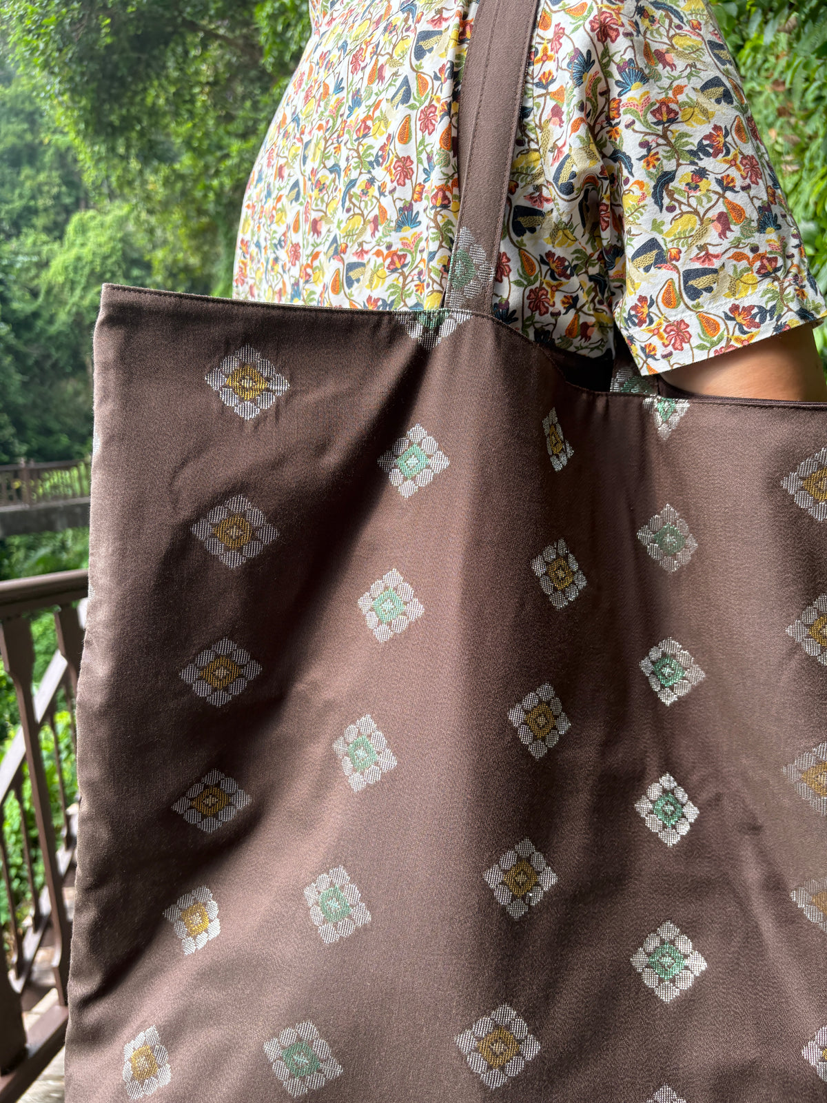A dark brown Songket fabric bag, handcrafted in Singapore.
