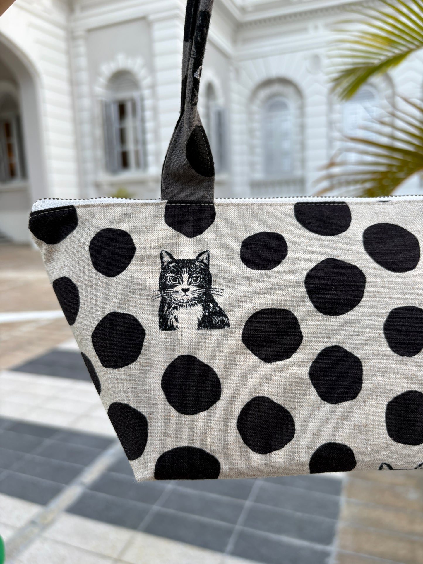 Polka dot handbag made from Japanese canvas featuring a cat print, handmade in Singapore. Finished with a YKK zipper and leather zipper puller.