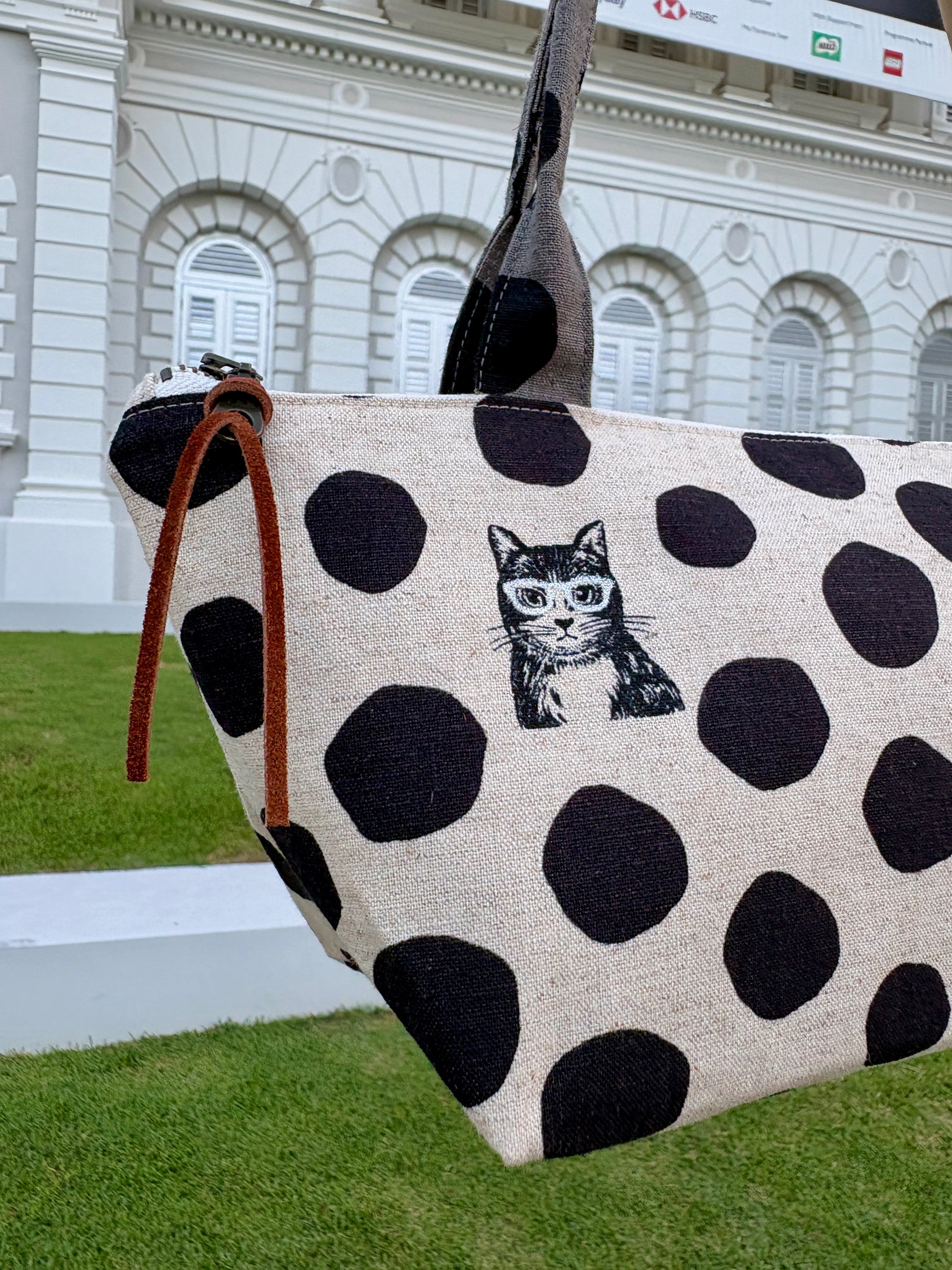 Polka dot handbag made from Japanese canvas featuring a cat print, handmade in Singapore. Finished with a YKK zipper and leather zipper puller.