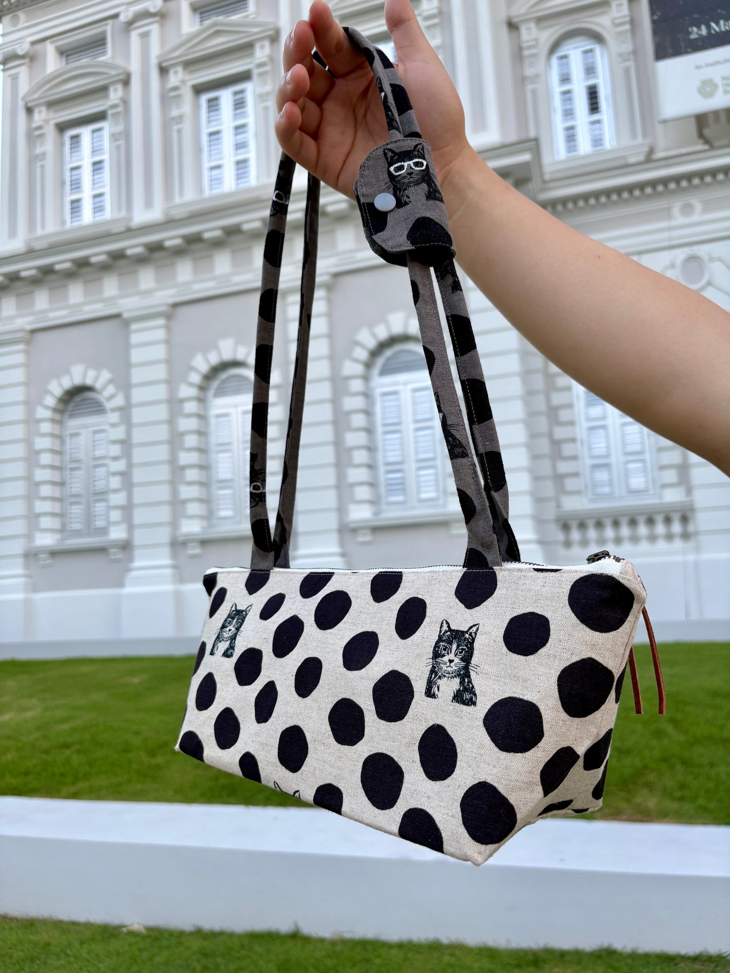 Polka dot handbag made from Japanese canvas featuring a cat print, handmade in Singapore. Finished with a YKK zipper and leather zipper puller.
