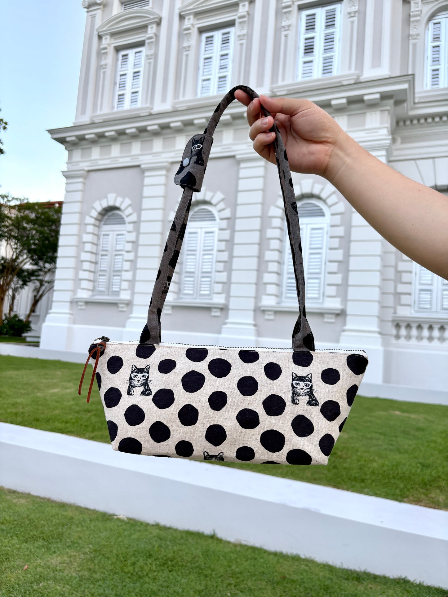 Polka dot handbag made from Japanese canvas featuring a cat print, handmade in Singapore. Finished with a YKK zipper and leather zipper puller.
