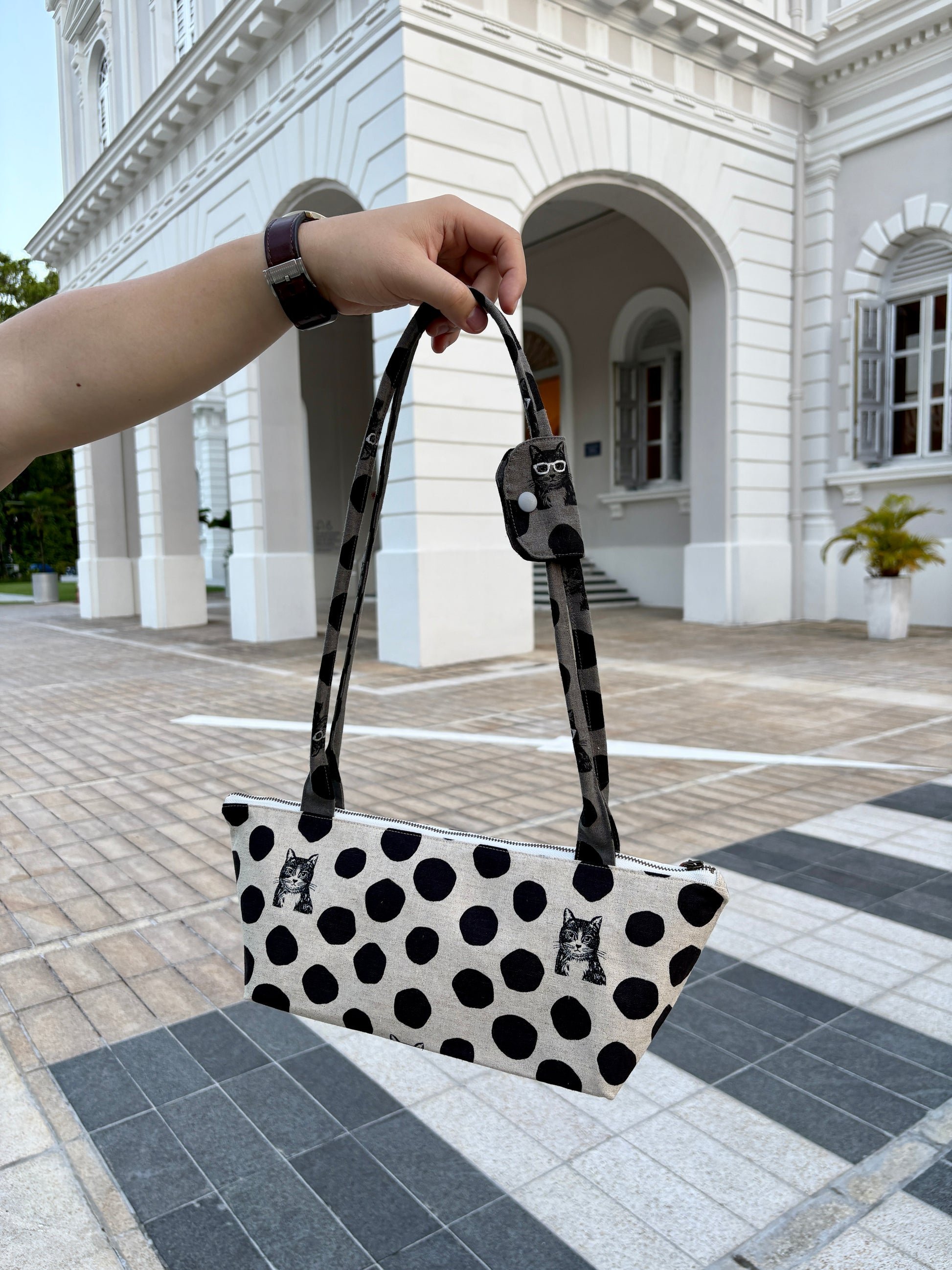 Polka dot handbag made from Japanese canvas featuring a cat print, handmade in Singapore. Finished with a YKK zipper and leather zipper puller.