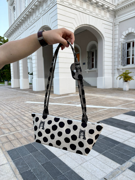 Polka dot handbag made from Japanese canvas featuring a cat print, handmade in Singapore. Finished with a YKK zipper and leather zipper puller.