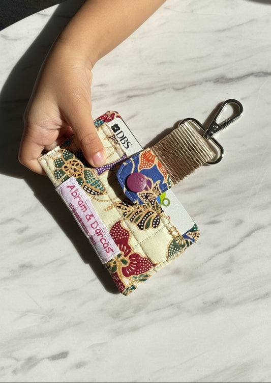 Quilted batik card holder with webbing strap and lobster clasp to hook onto bag or lanyard or keys. Handmade in Singapore.