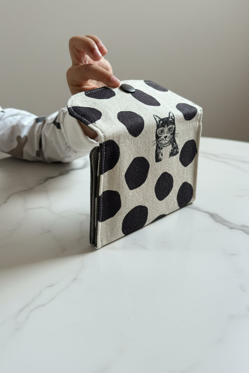 White Japanese canvas fabric with black polka dots and cats, used to create a unique wallet handmade in Singapore.