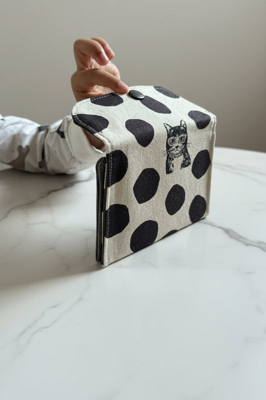 White Japanese canvas fabric with black polka dots and cats, used to create a unique wallet handmade in Singapore.
